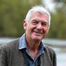 Portrait of David Lee amidst fishing gear, smiling